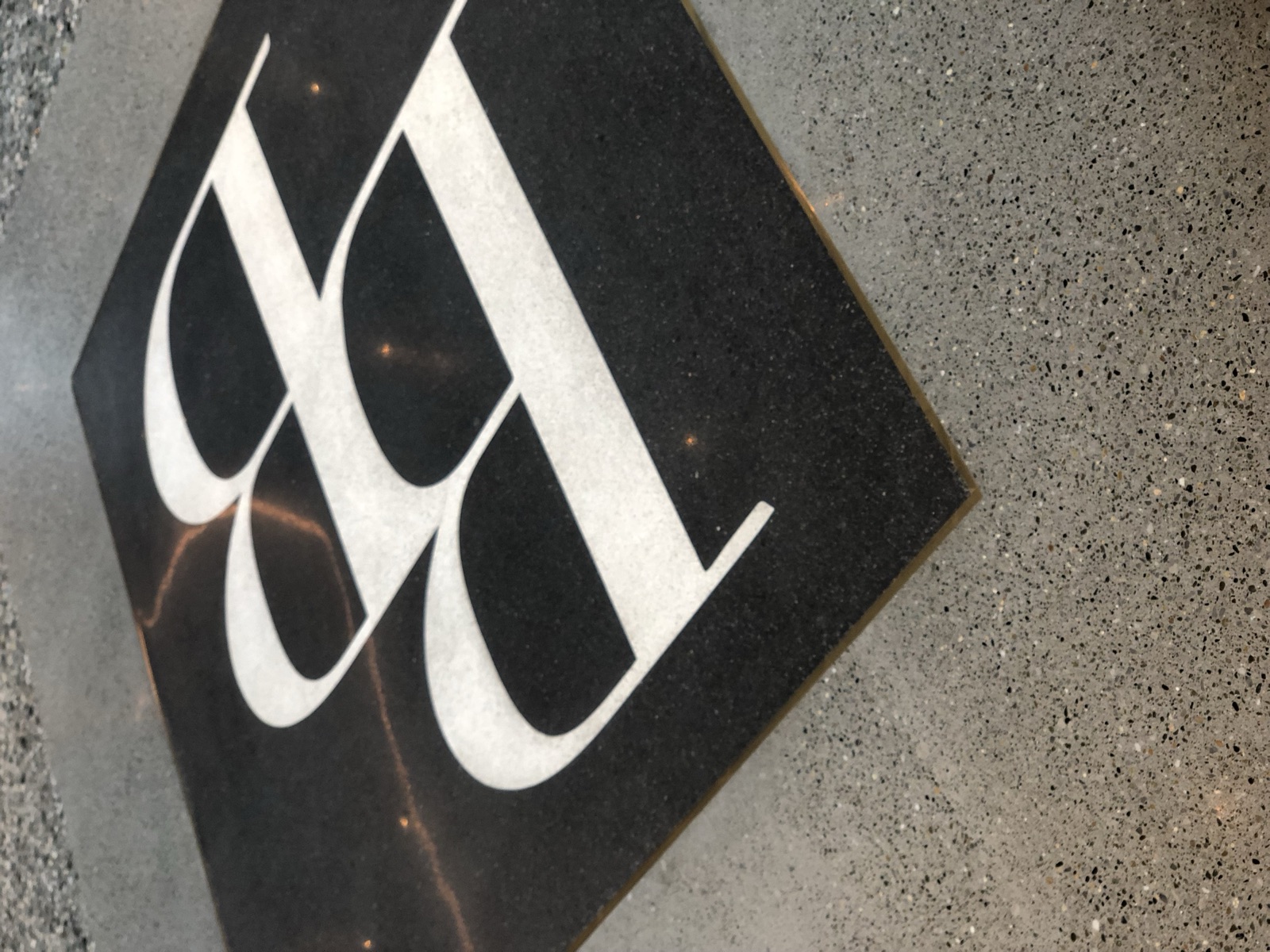 Polished concrete floor detail with logo inlay.