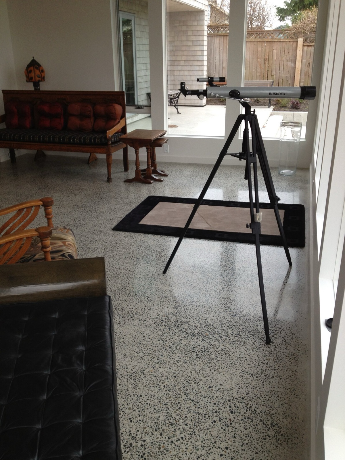 Private waterfront residence terrazzo detail with telescope and seating.
