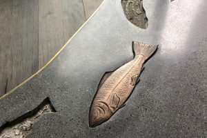bronze fish in concrete