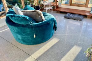 blue couch on terrazzo floor