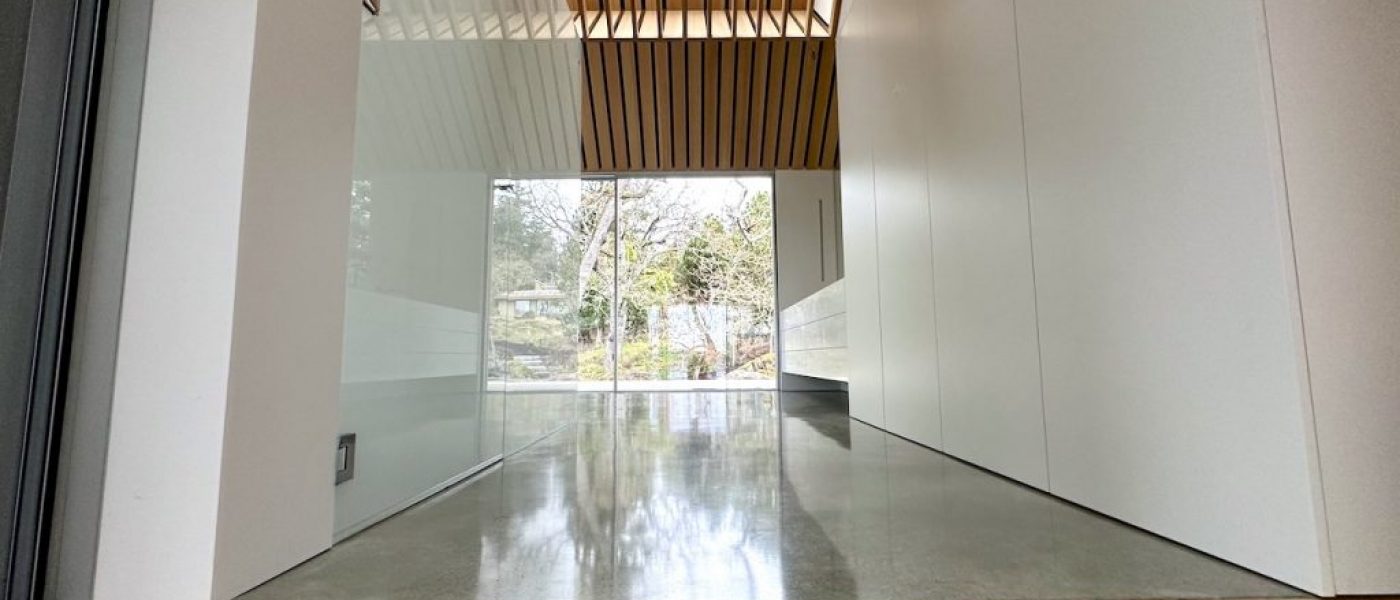 wood floor contrasts the grey polished concrete and white walls in this modern house